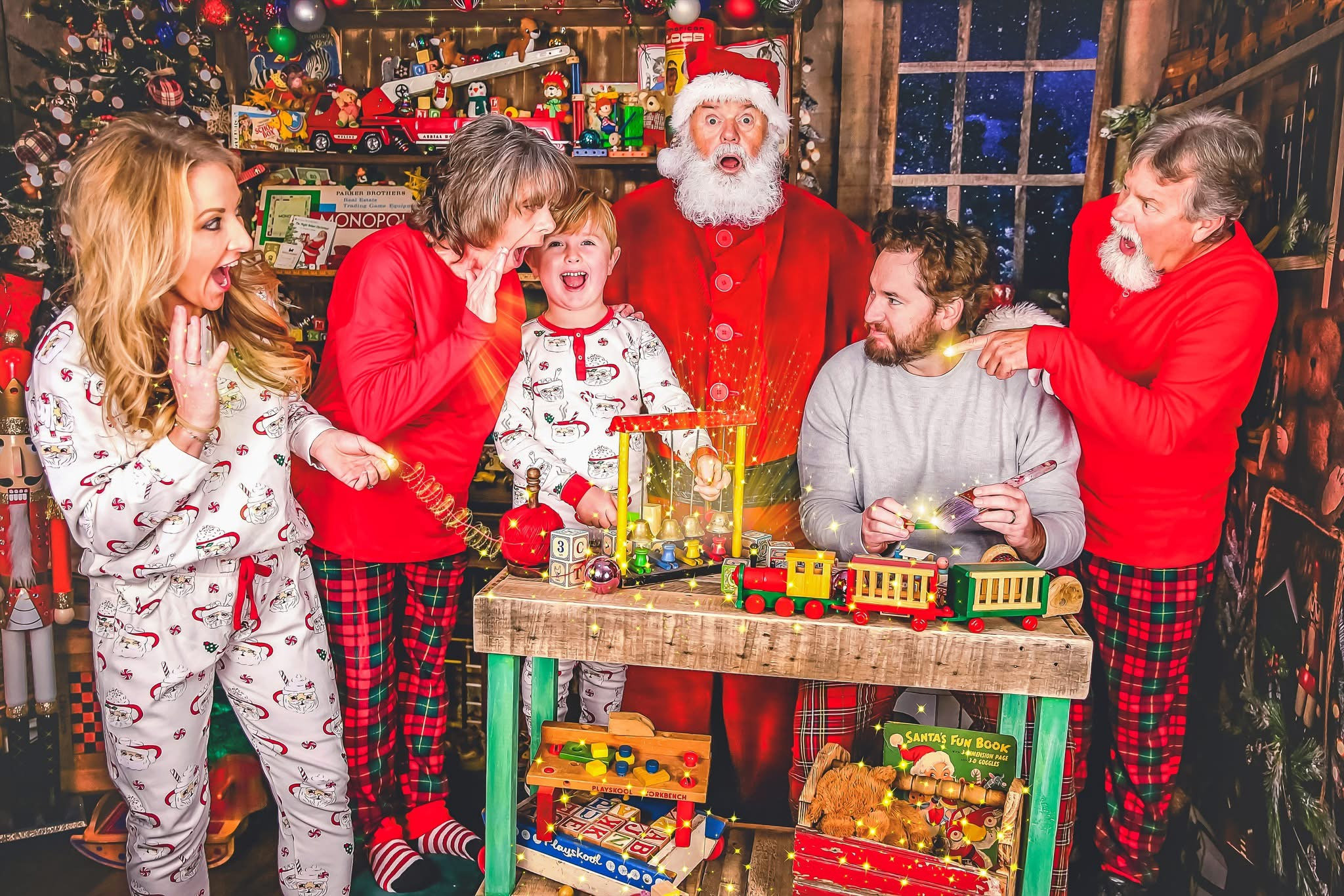 A family sharing a magical moment with Santa in his workshop
