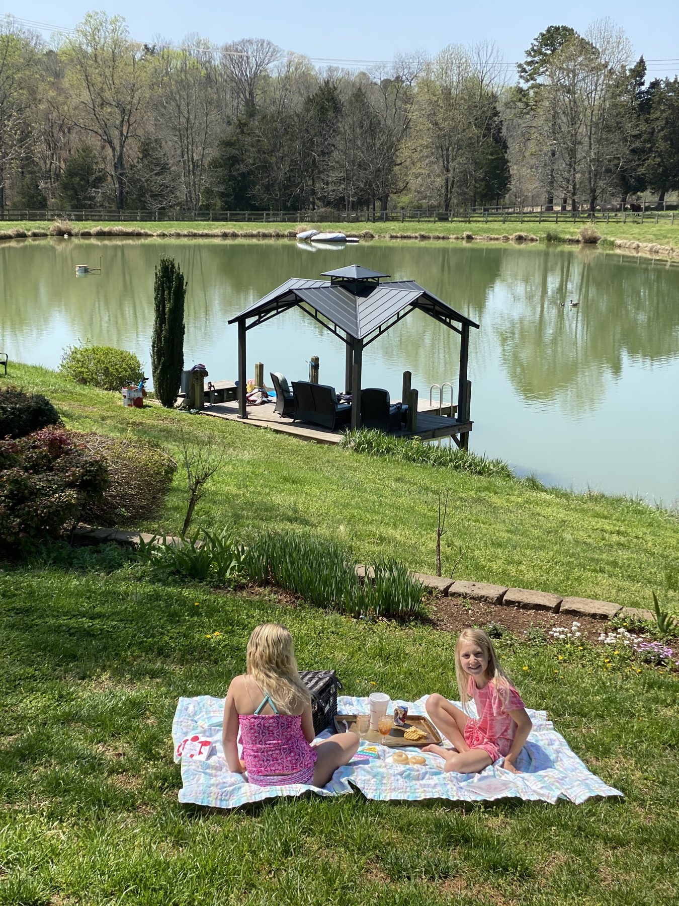 Campers picnicking by the pond