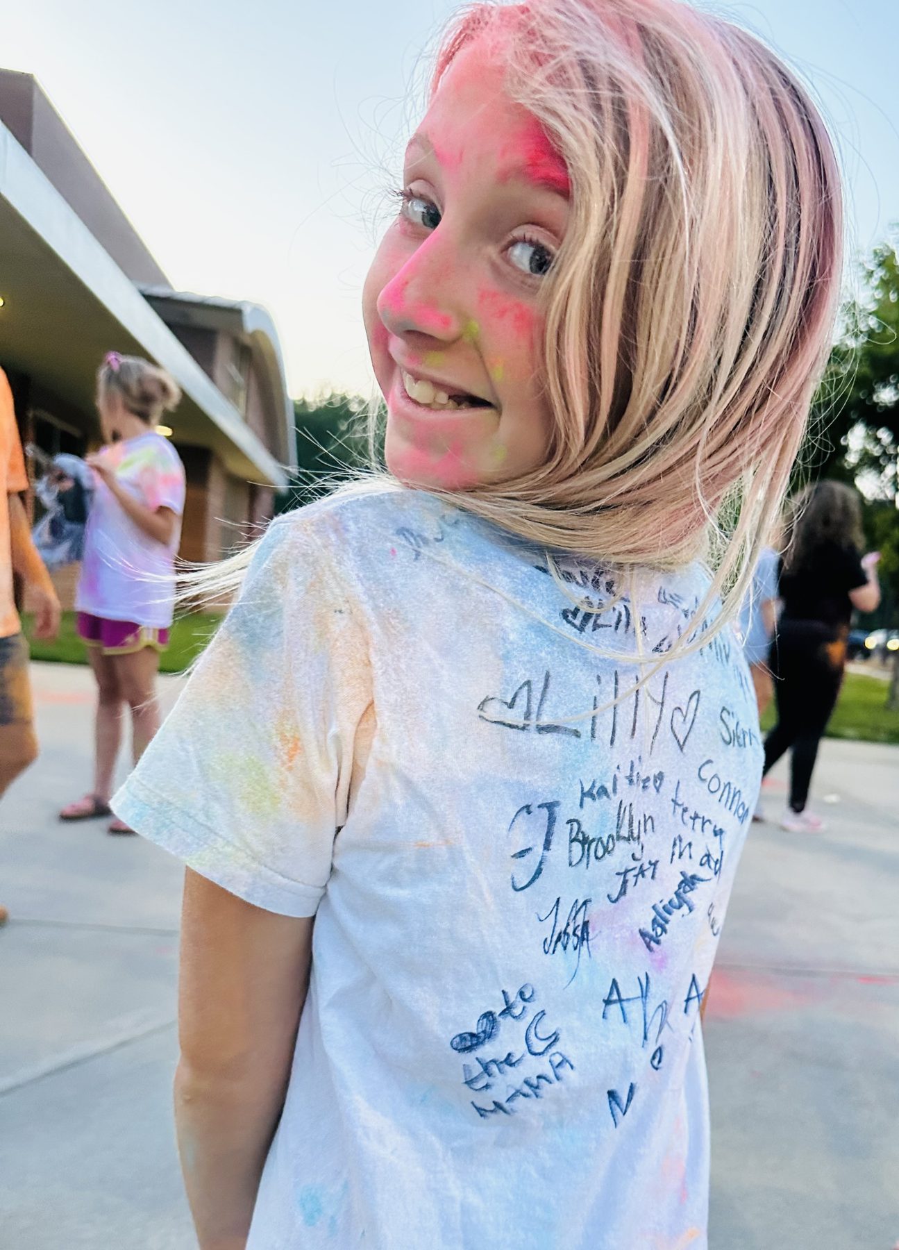 A camper in a signed tie-dye shirt