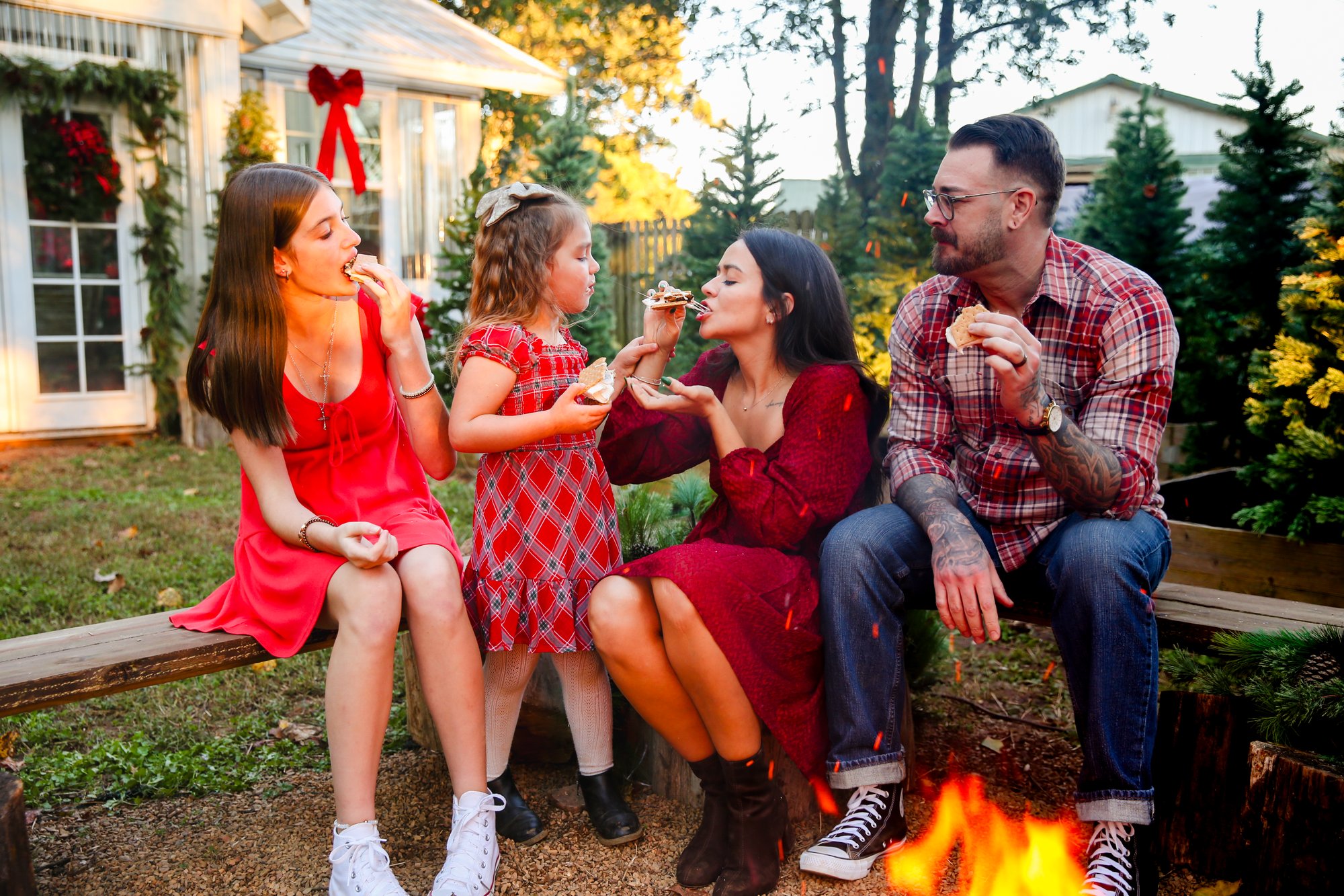 A family sharing s'mores by the fire pit